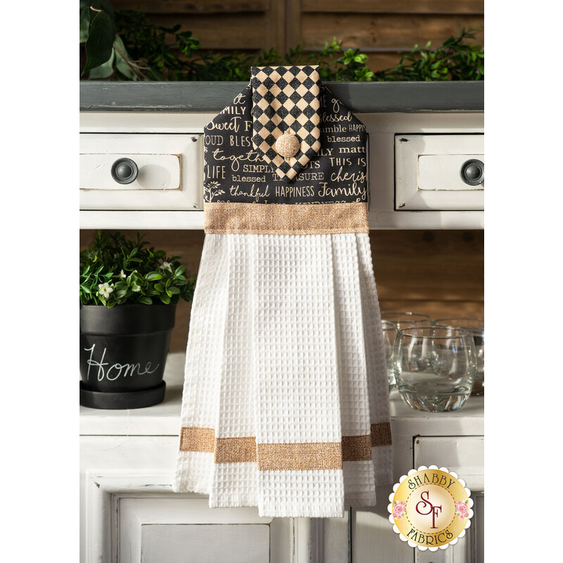 Printed word pattern towel hanging from table drawer