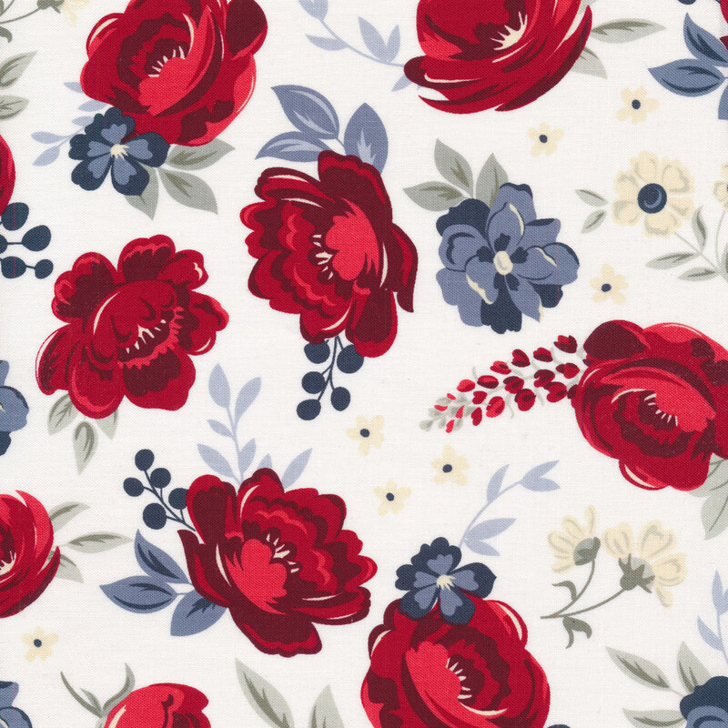 Red and blue florals and sprigs on fabric with an off white background