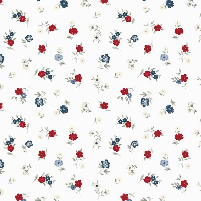 Fabric with red, white, and blue ditsy florals on an off white background