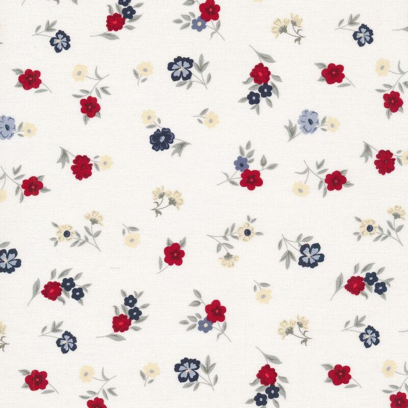 Fabric with red, white, and blue ditsy florals on an off white background
