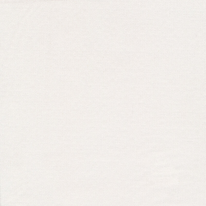 A white on white fabric with small swirled accents