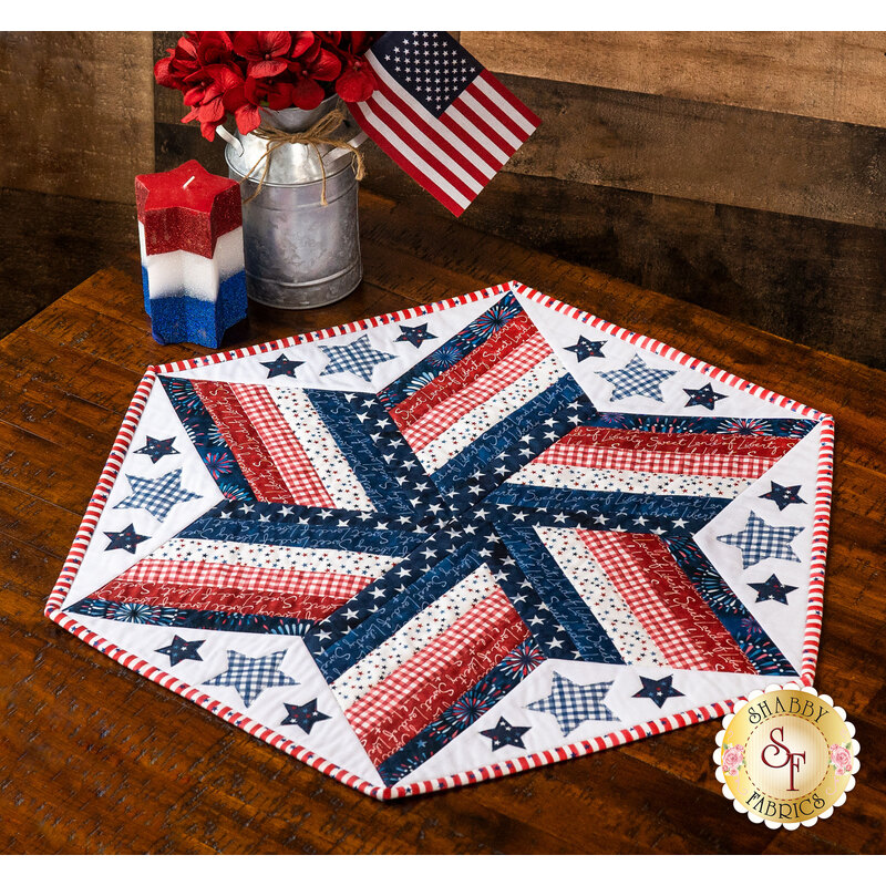 Hexagonal table topper made with patriotic fabrics in a diamond star formation.