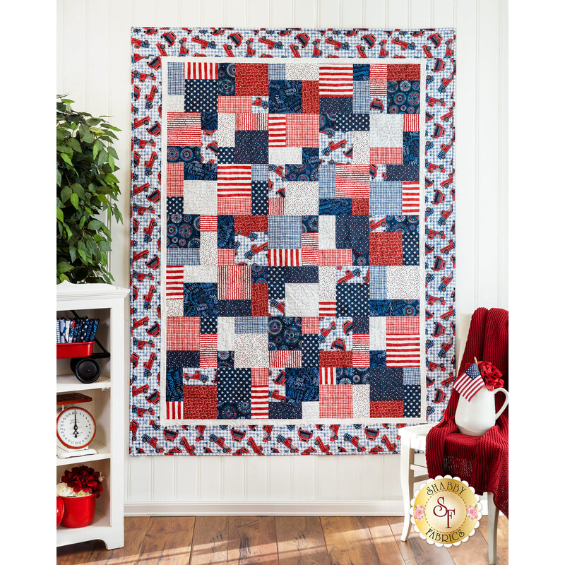 Hanging quilt filled with red white and blue patriotic imagery.