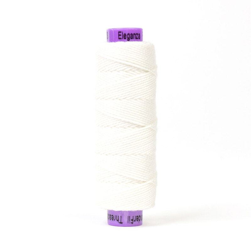 A spool of WonderFil Eleganza EZ06 Snow Globe thread on a white background