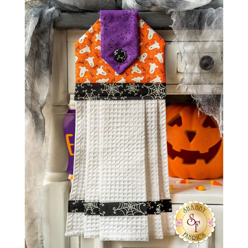 Hanging towel with Halloween themed imagery and white waffle texturing.