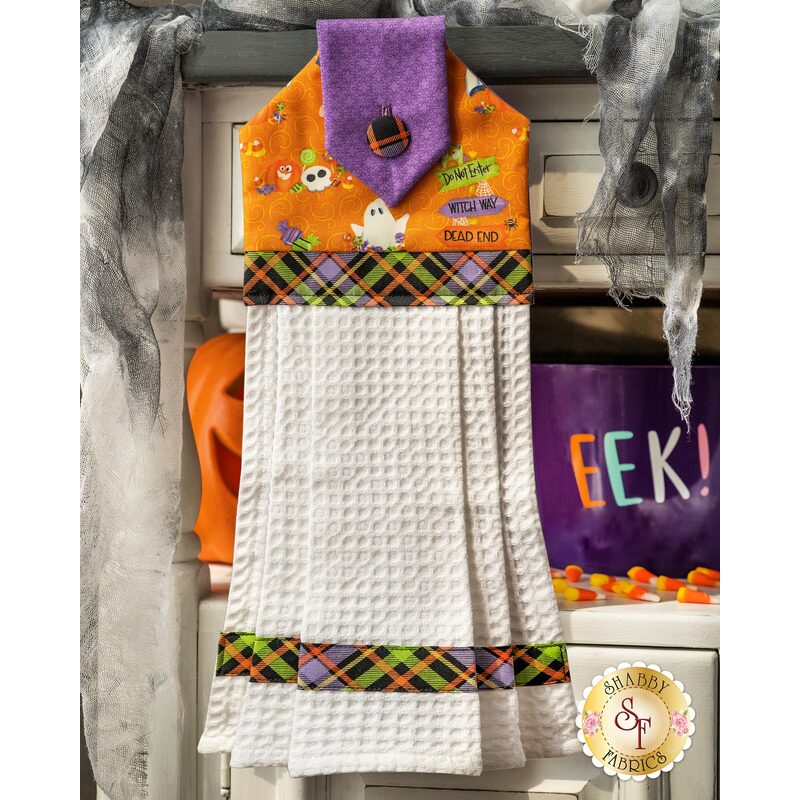 Hanging towel with halloween themed imagery and white waffle texture.