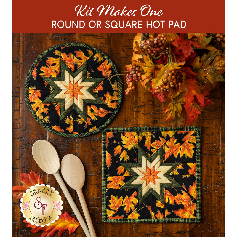 Two hot pads with leaf pattern and black background featuring a central folded star design, on wood table next to wood spoons.