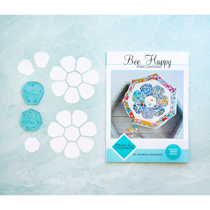 The Bee Happy Pincushion Pattern, acrylic templates, and english paper pieces on a light blue background