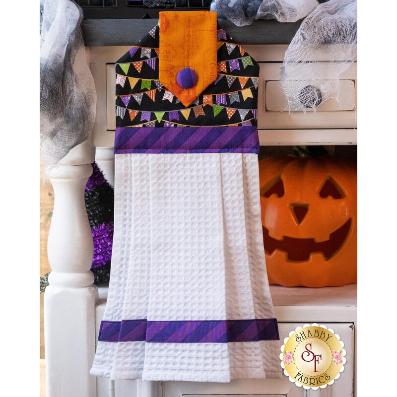 Hanging towel with Halloween colors, pennant imagery and white waffle texture.
