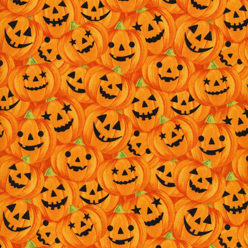 Orange fabric filled with orange Halloween pumpkins throughout