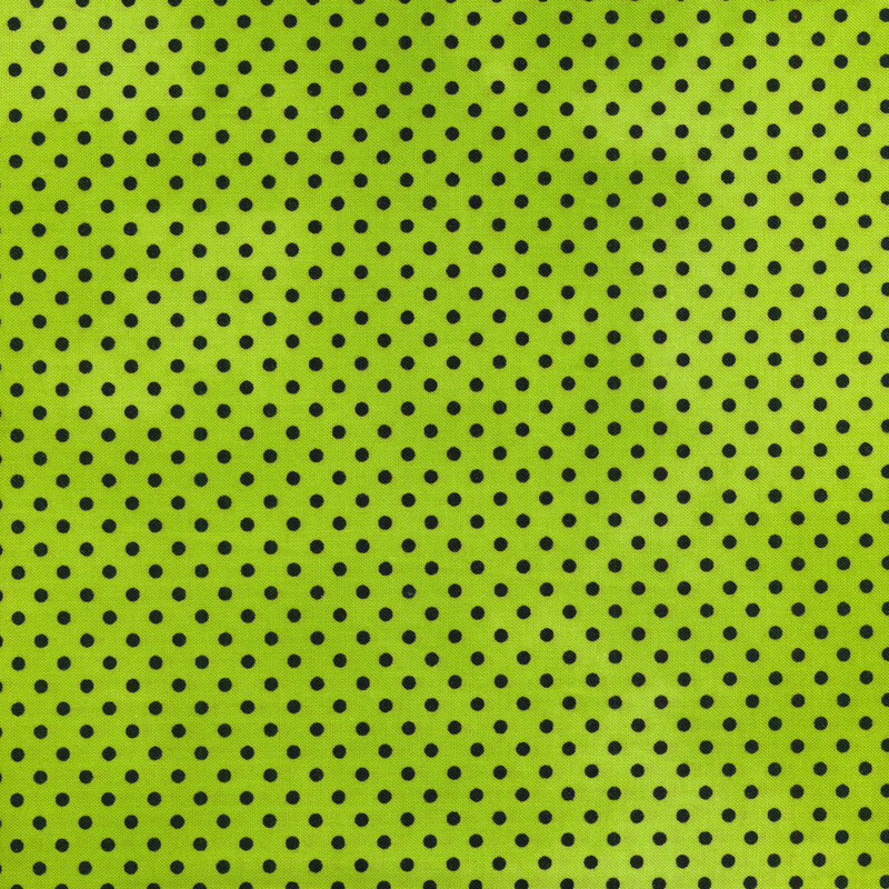 Bright lime green fabric with black polka dots throughout