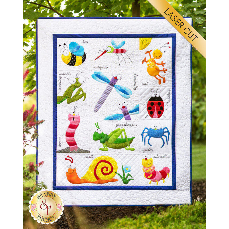 White quilt with blue border surrounding many appliqué cartoon styled bug characters.