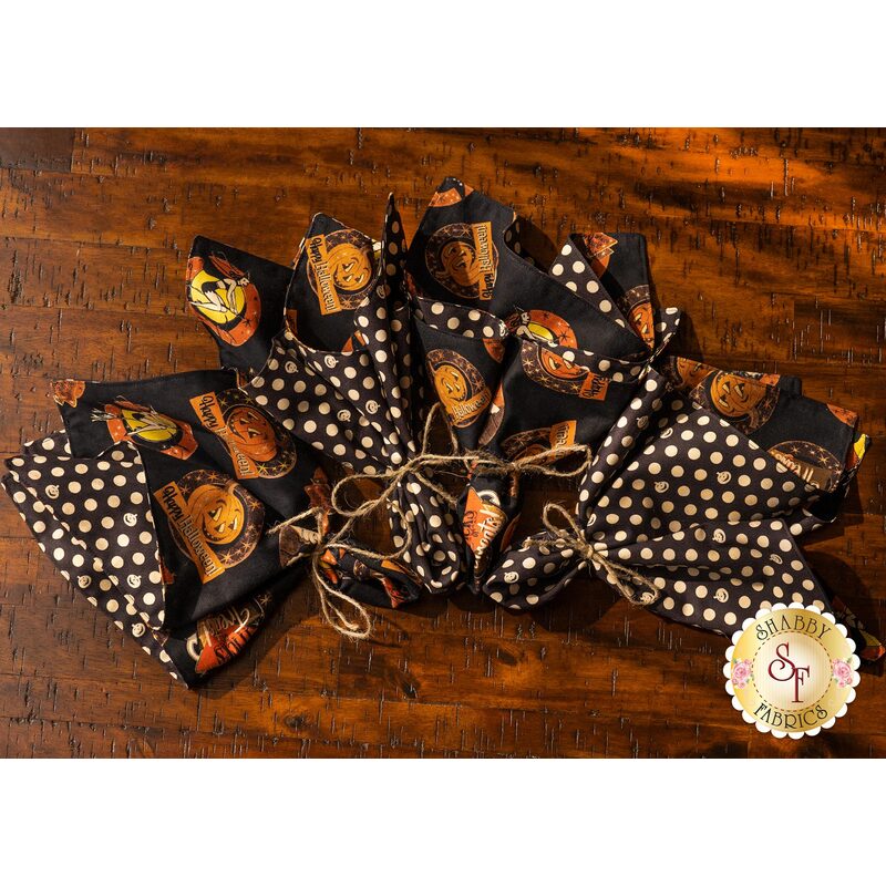 Black cloth napkins with Halloween themed motifs and polka dots.