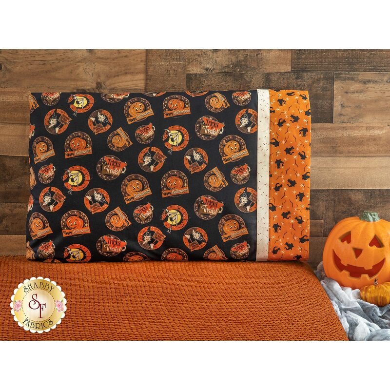 Halloween themed black pillowcase featuring witches, jack-o-lanterns, and phrases with orange banding featuring black cats.