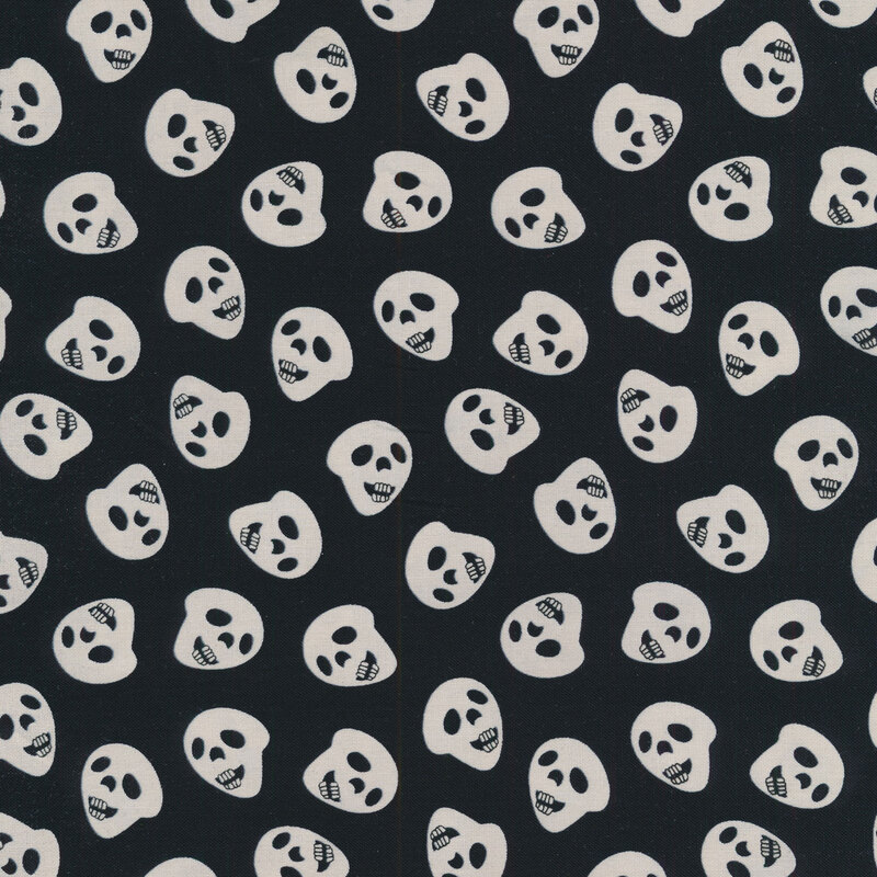 Black fabric with tossed white skulls all over