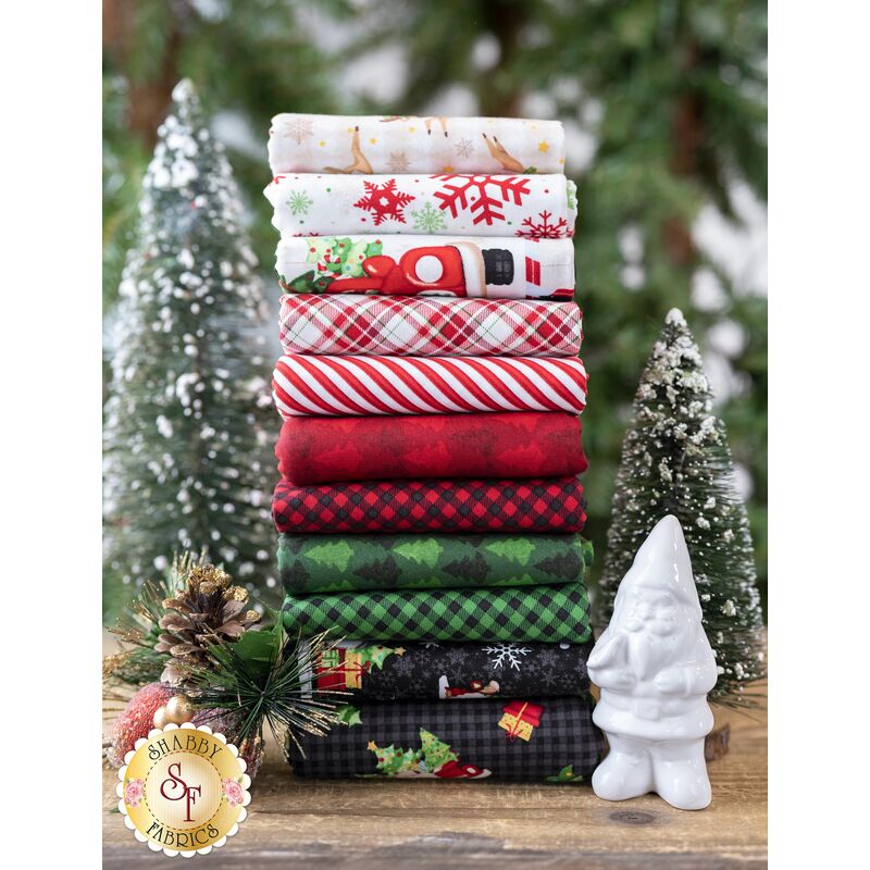 A stack of gnome fabrics in the Timber Gnomies Tree Farm fabric collection