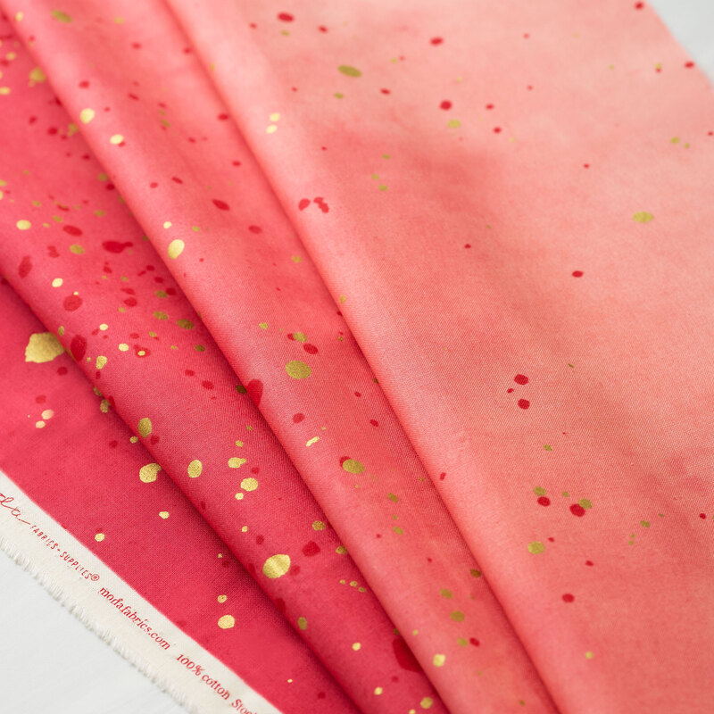 A pink ombre fabric with metallic accents.