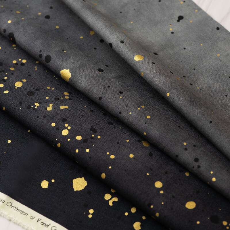 A black ombre fabric with metallic accents.