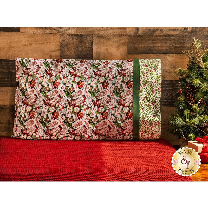 Pillowcase featuring Christmas gift tags with holiday phrases and holly with ribbons on the right side edge.