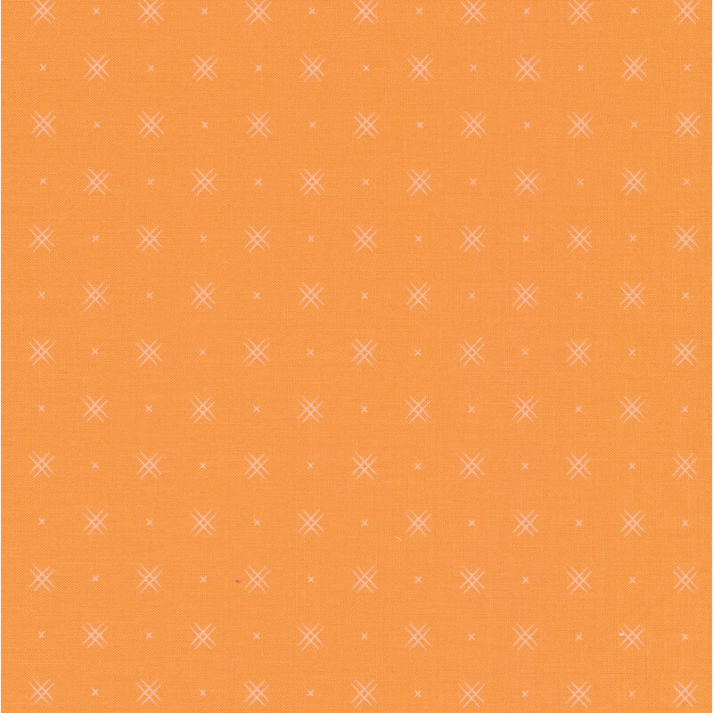 Apricot colored fabric with rows of small white x's and double criss-cross patterns