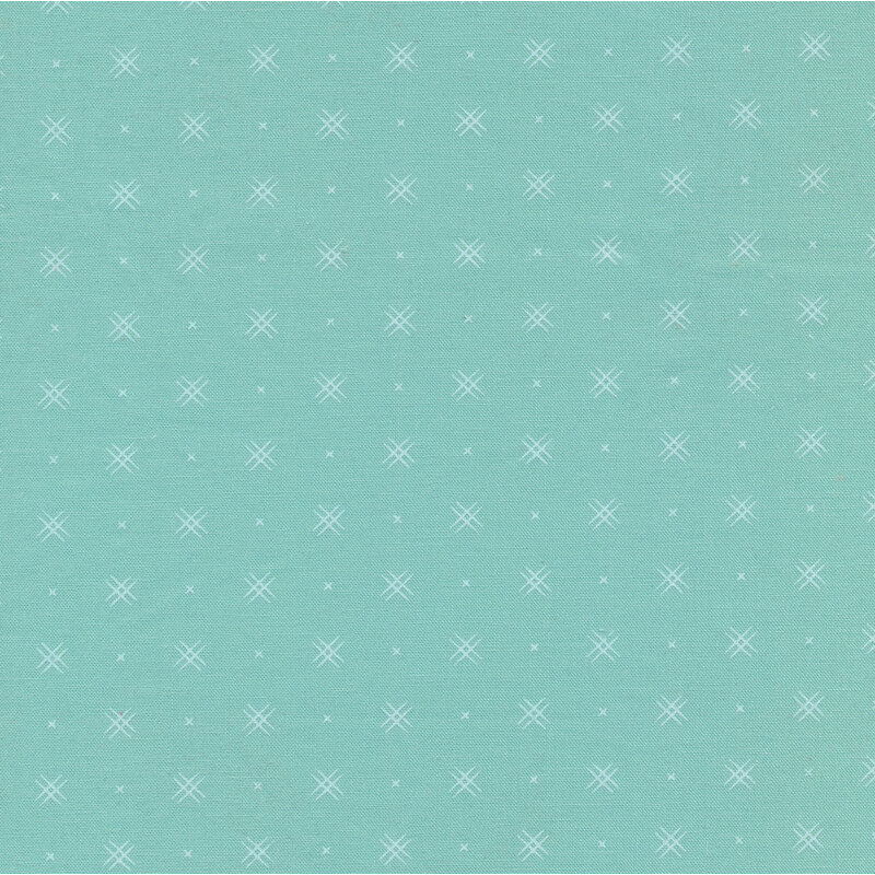 Aqua fabric with rows of small white x's and double criss-cross patterns