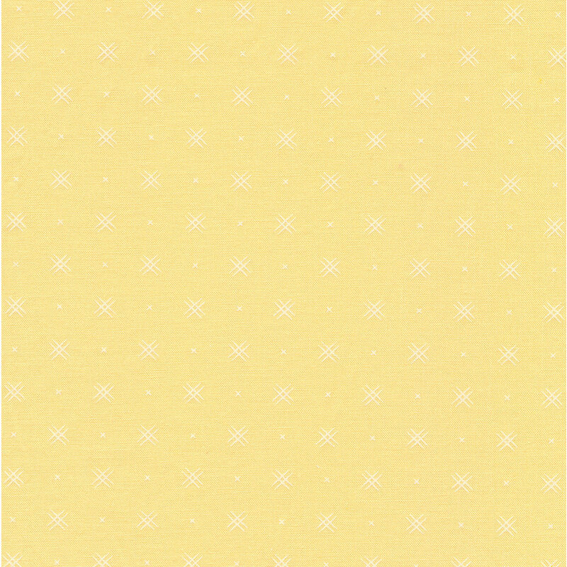 Light yellow fabric with rows of small white x's and double criss-cross patterns