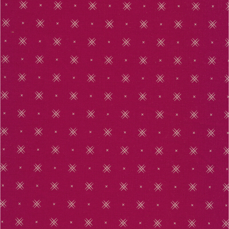 magenta fabric with rows of small white x's and double criss-cross patterns