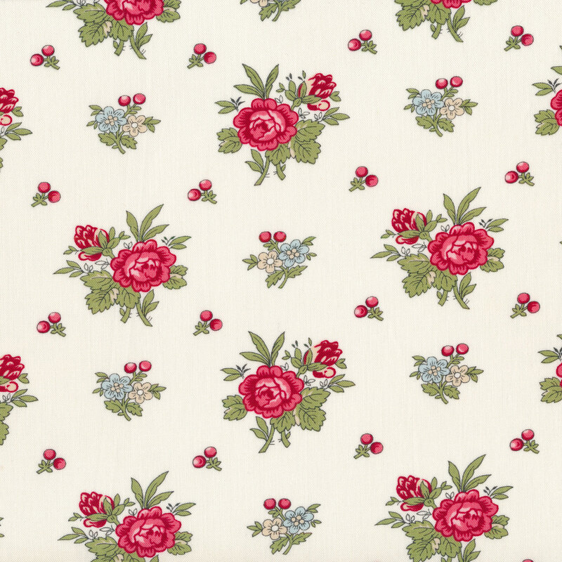 Tossed red rose bunches and holly berries on a cream background