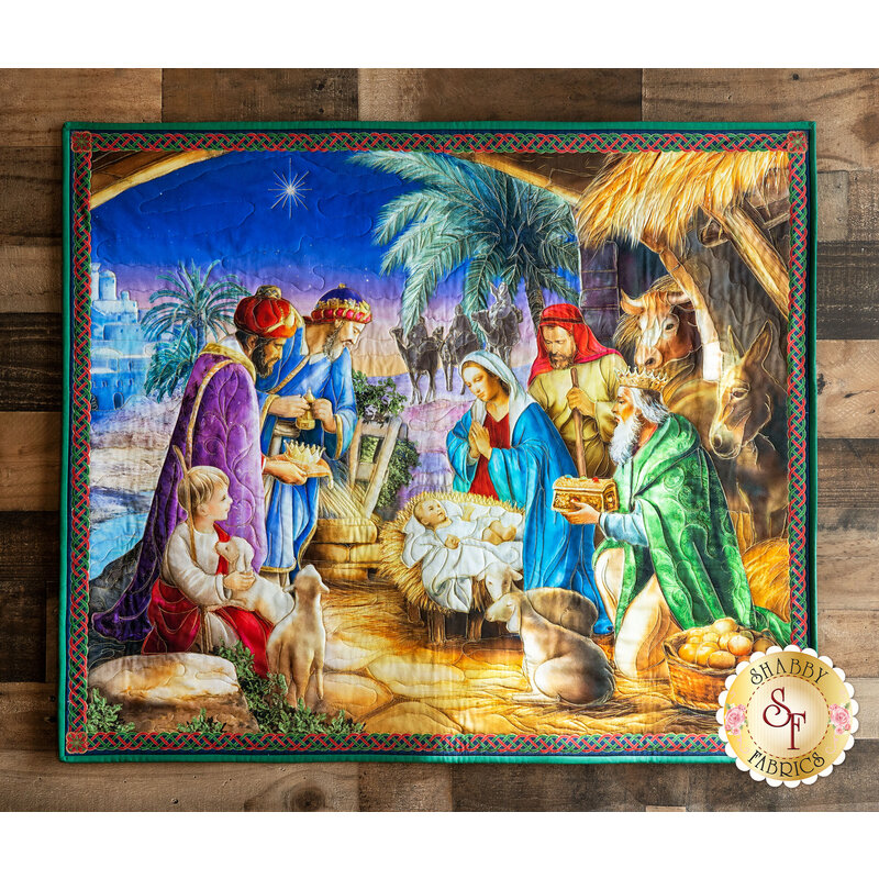 Illustrated Nativity scene panel wall hanging with vivid colors and red and green binding, hanging on wood wall.