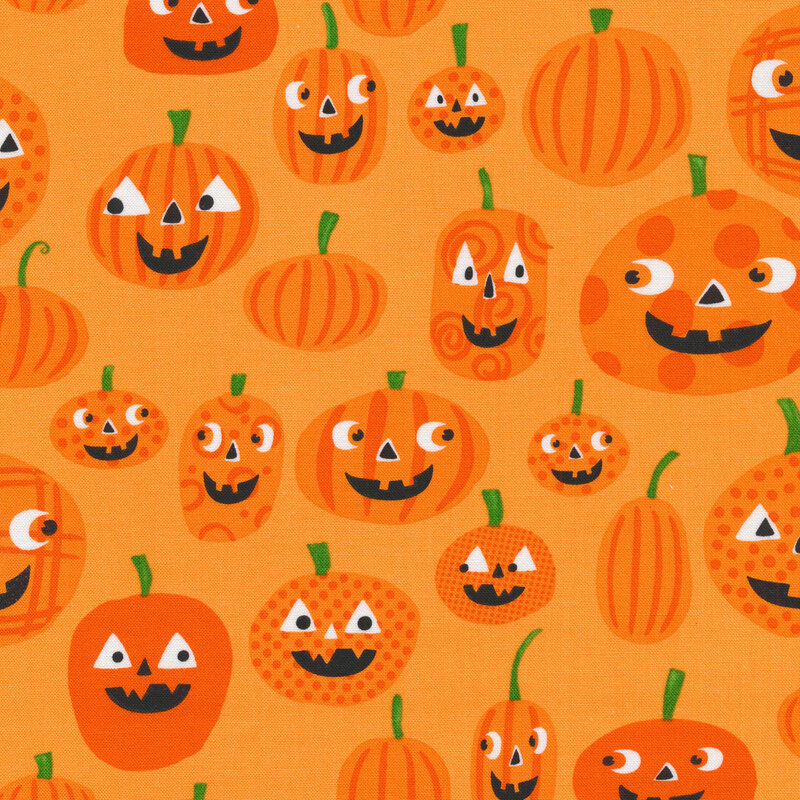 Fabric featuring Smiling jack-o-lanterns on an orange background