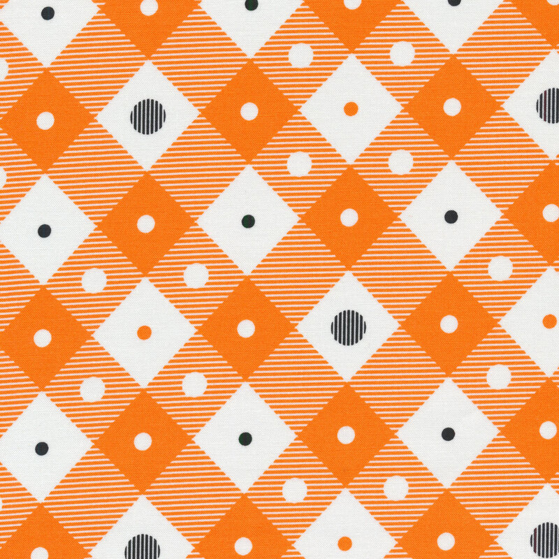 White and orange plaid fabric with white, orange, and black polka dots