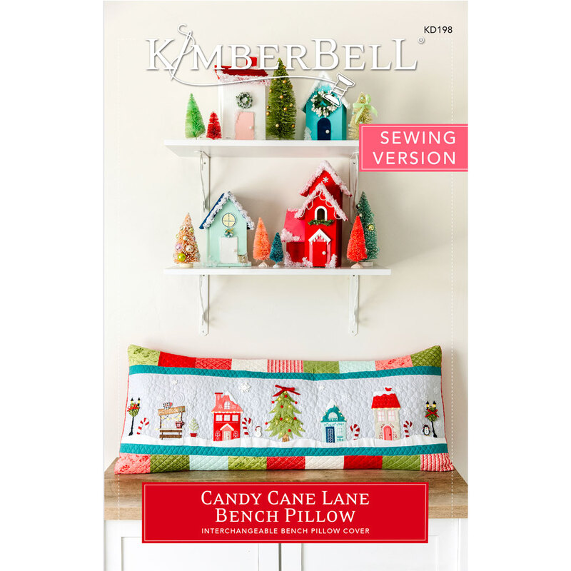 Bench pillow featuring Christmas decorated shops and homes.