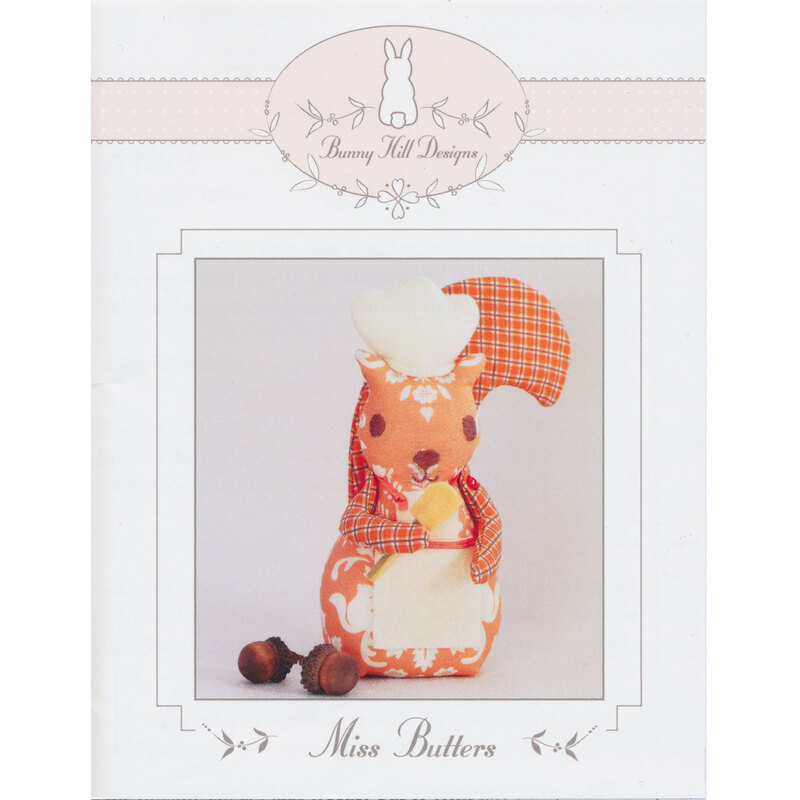 The front of the Miss Butters pattern by Anne Sutton for Bunny Hill Designs featuring the finished stuffed squirrel chef.