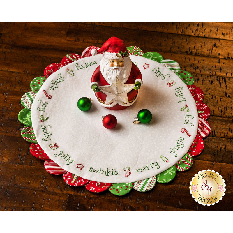 White Scalloped Table Topper with red and green scallops featuring Christmas themed embroidery.