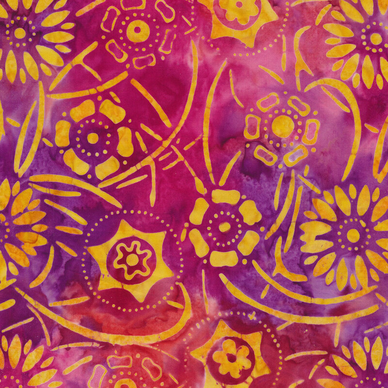 Orange floral on a pink, red, and purple watercolor Batik fabric background.