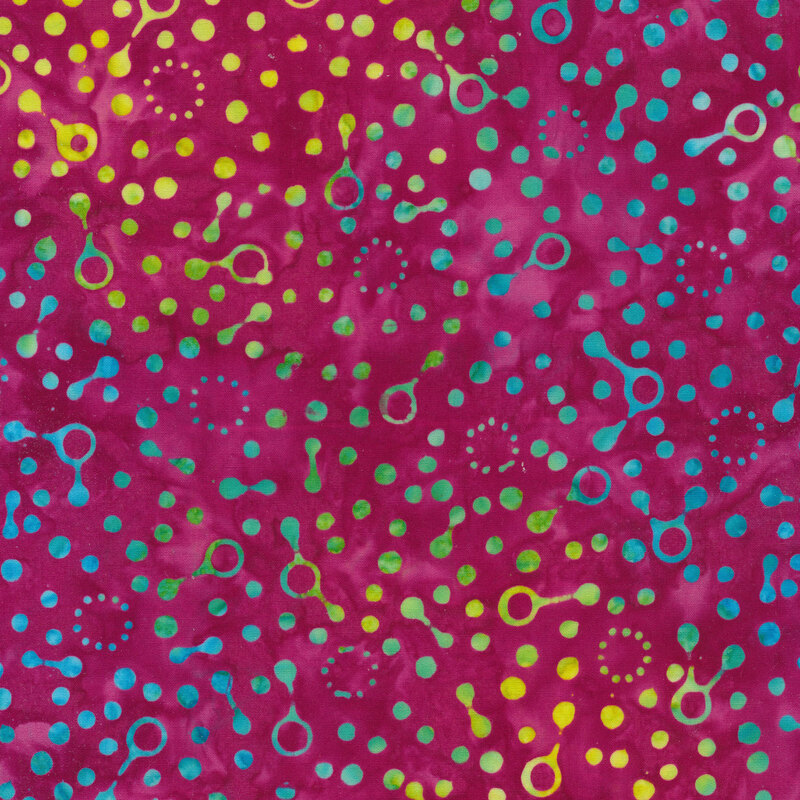 Green and blue dotted pattern on a magenta Batik fabric background.