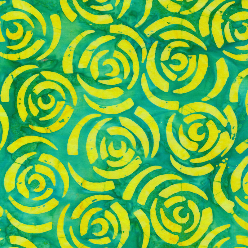 Abstract yellow roses on a green Batik fabric background.