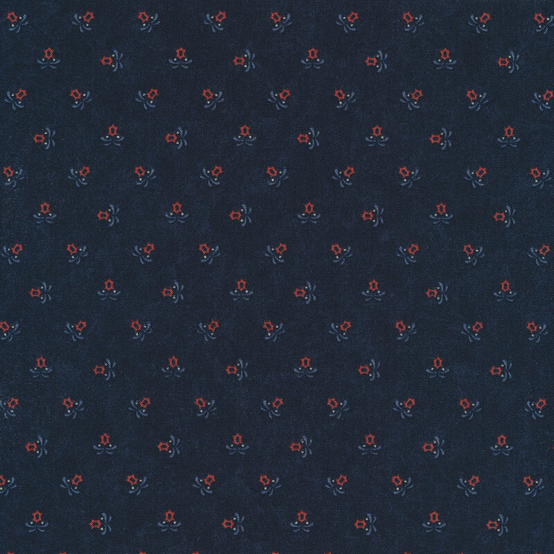 Fabric of red star flowers on a navy background.