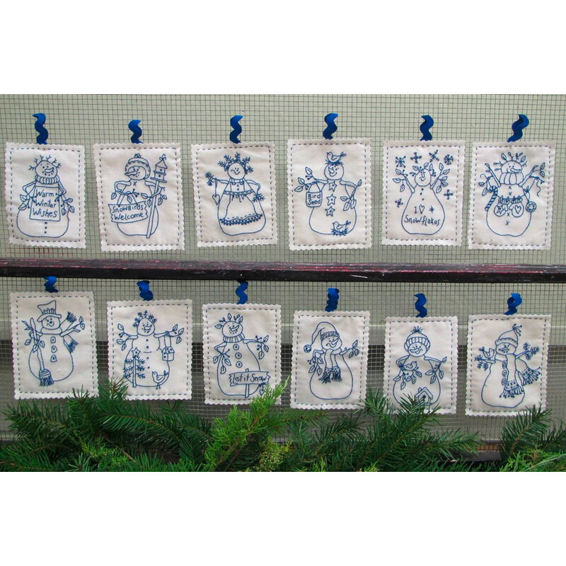 12 squares of fabric with Blue thread embroidered snowmen on white