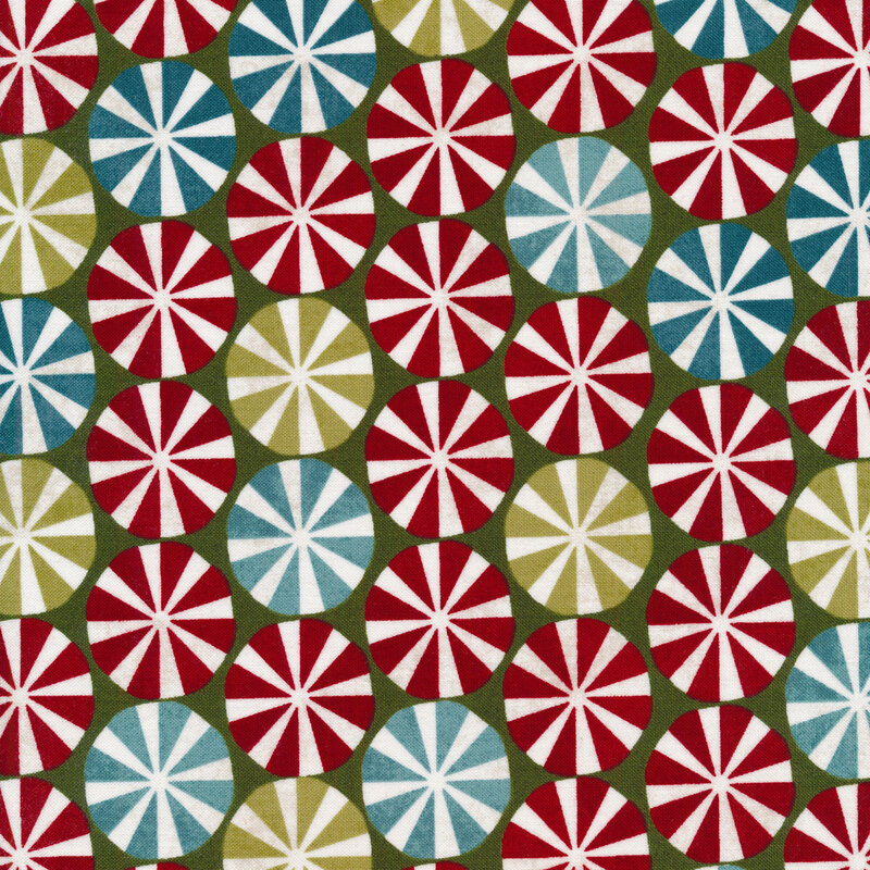 Fabric of multicolor peppermint candies on a green background
