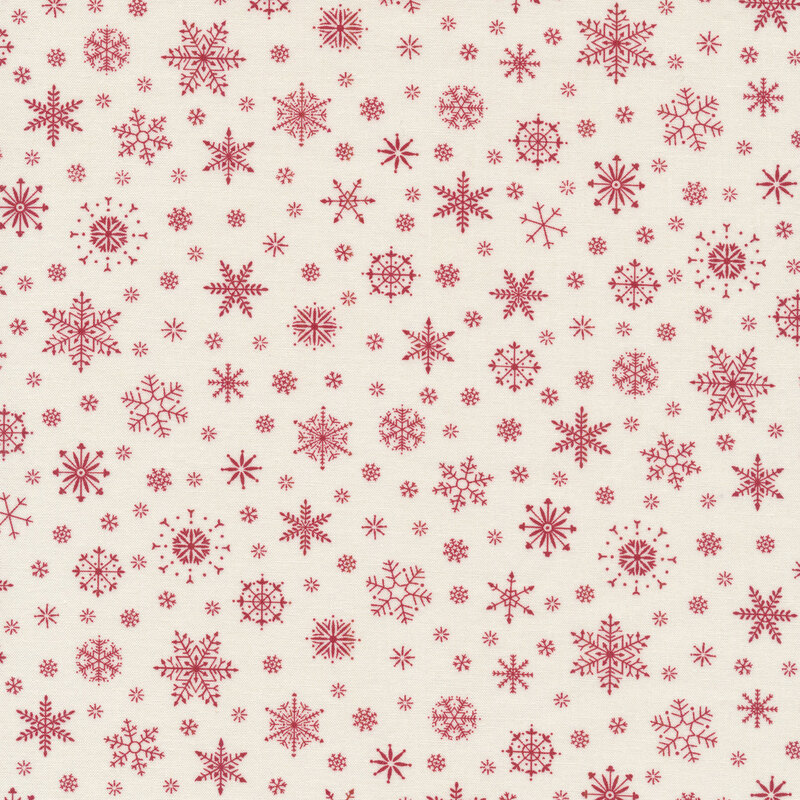 Fabric of scattered red snowflakes on a cream background