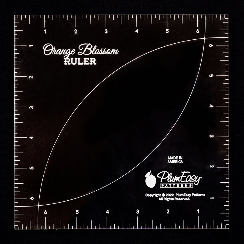 Orange blossom square ruler with markings for seven inches on all sides.