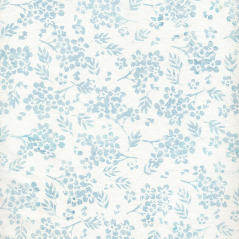 White fabric with small blue floral bunches and leaves