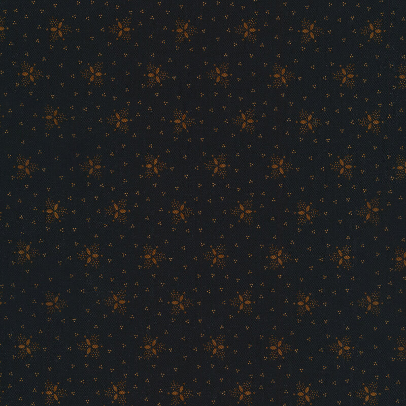 golden brown trefoils scattered all over a black fabric background