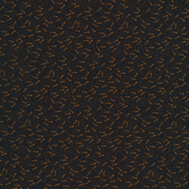 golden brown fireworks and swirls all over a black fabric background