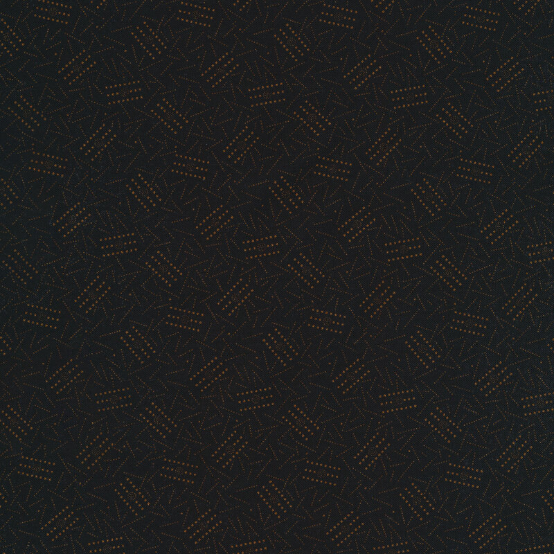 golden colored lines scattered all over a black fabric background 