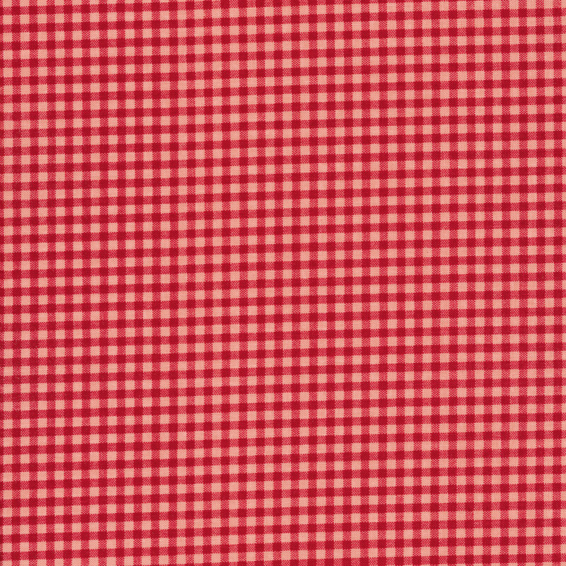 Fabric of a tonal red gingham on a pink background