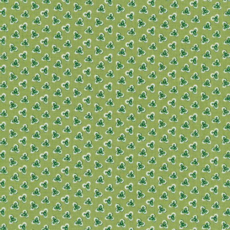 Ditsy fabric with three petal flowers on a green background
