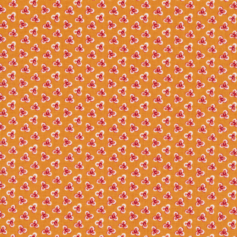Ditsy fabric with three petal flowers on an orange background