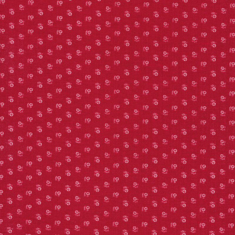Fabric with an array of tiny white flowers on a red background